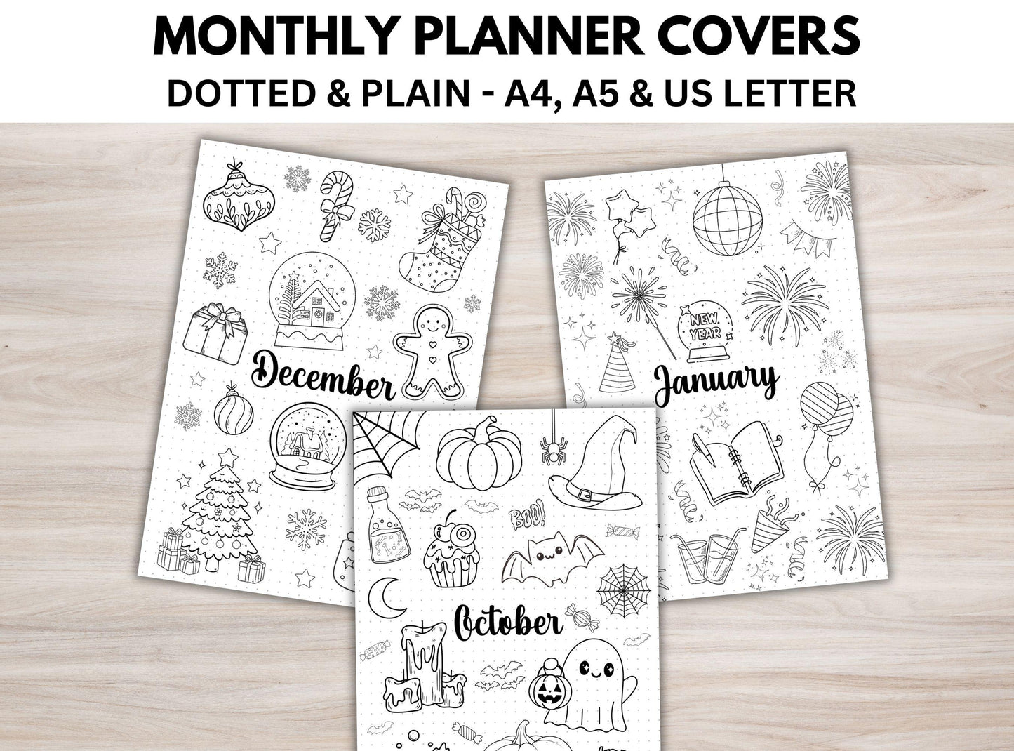 Three monthly planner covers for December, January, and October on a wooden surface.