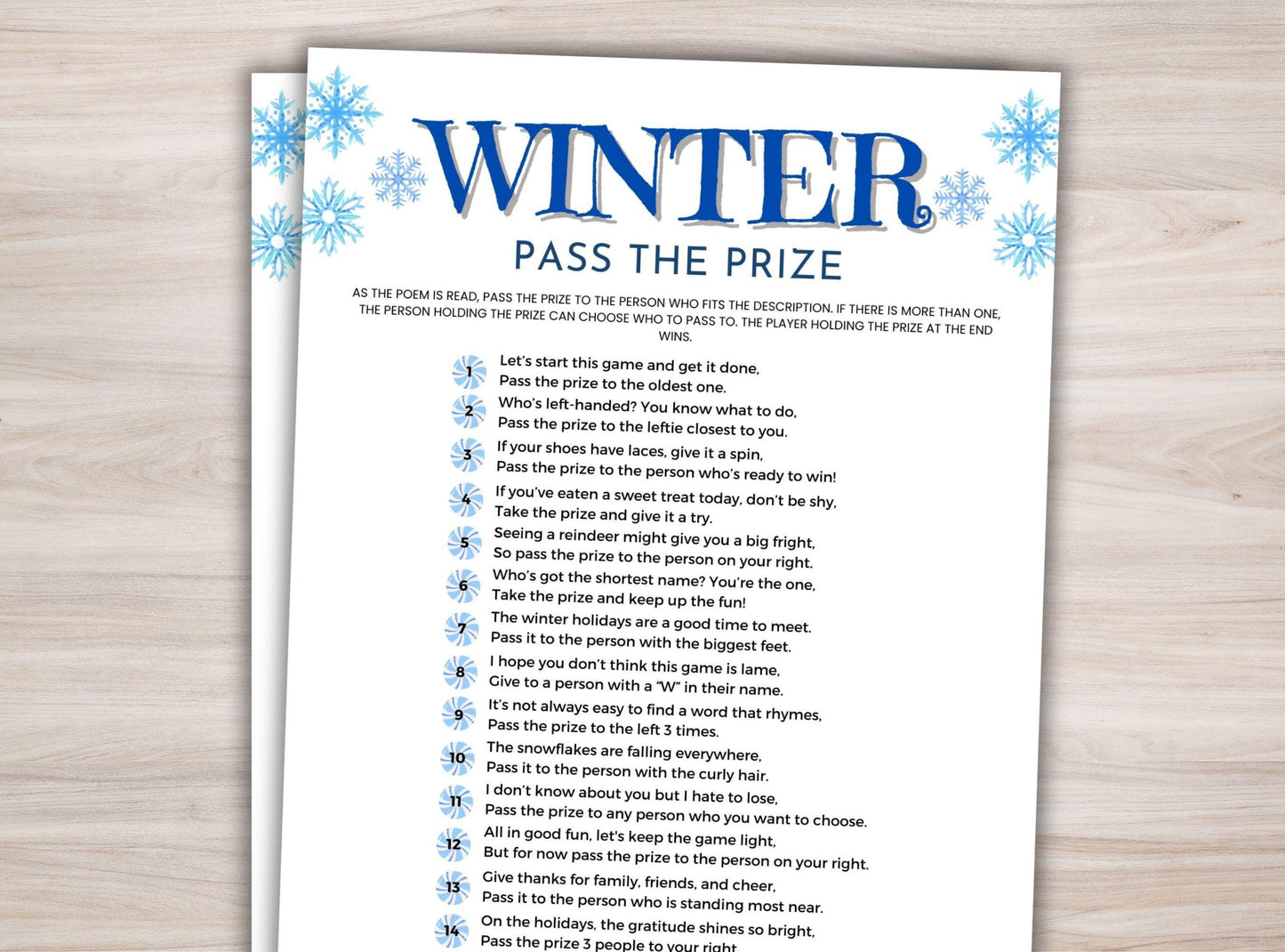 Sheet of paper with 'Winter Pass the Prize' game instructions on a wooden surface