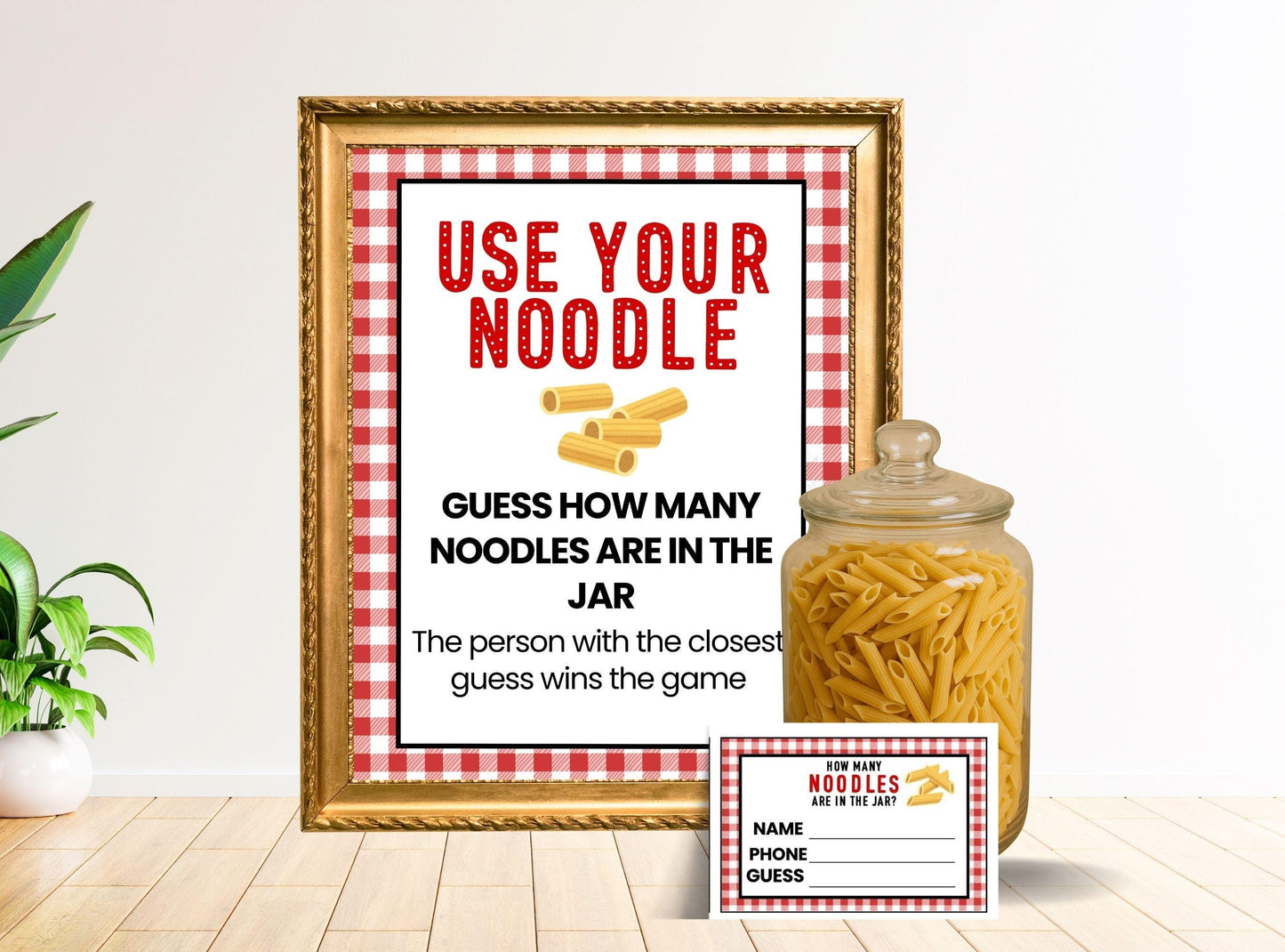 Framed print with 'Use Your Noodle' text and a jar of noodles on a table.
