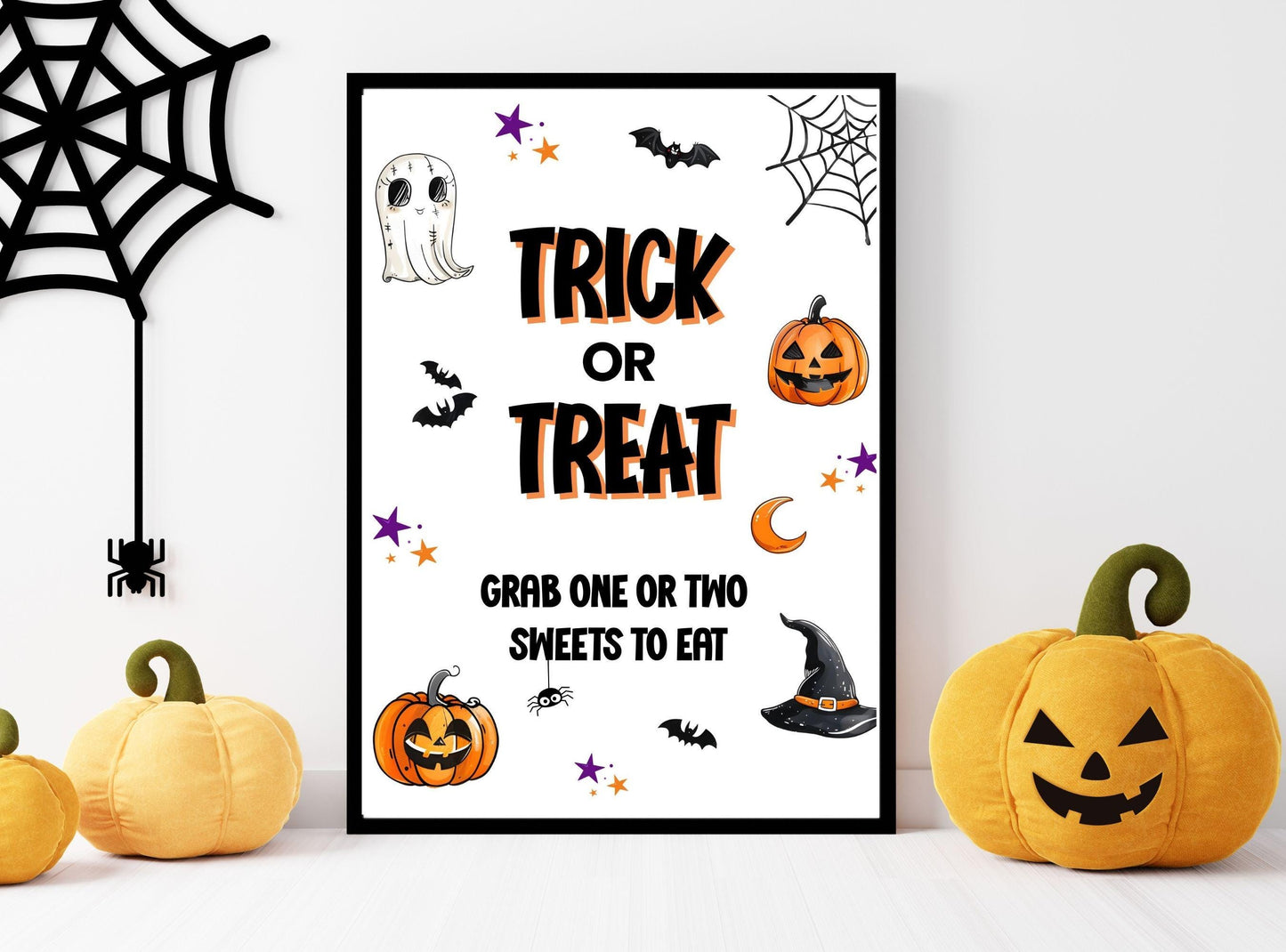 Halloween-themed poster with 'Trick or Treat' text, surrounded by pumpkins and spider webs on a white background.