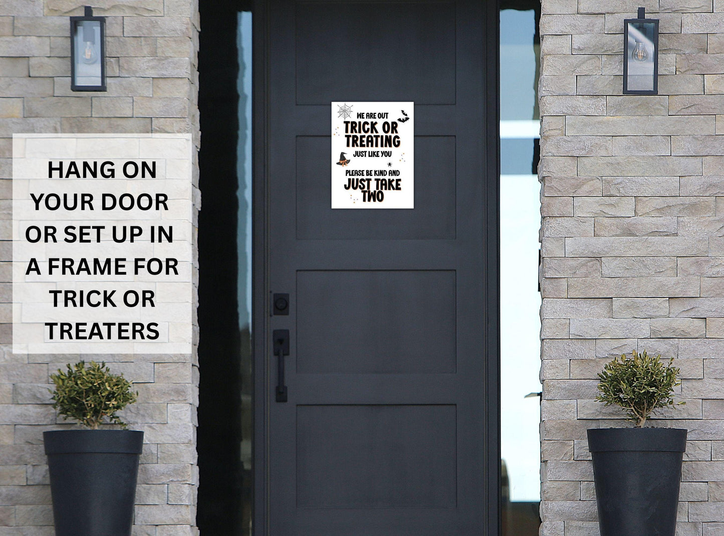 Decorative sign on a door with text for trick or treating, surrounded by stone walls and potted plants.