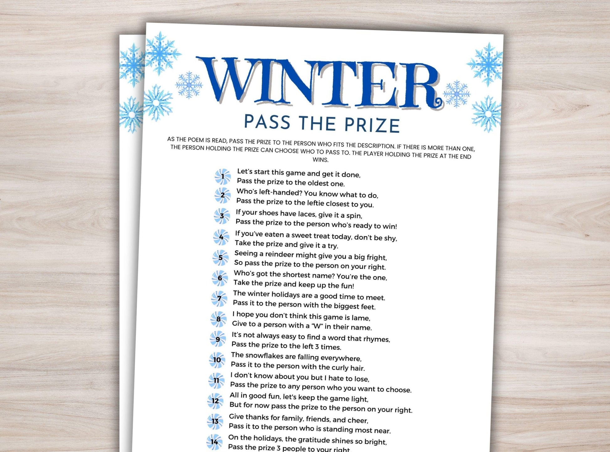 Sheet of paper with 'Winter Pass the Prize' game instructions on a wooden surface