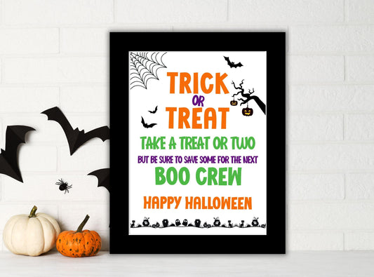 Halloween-themed framed print with decorative elements on a white wall.