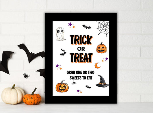 Framed Halloween-themed print with text and graphics on a white wall.